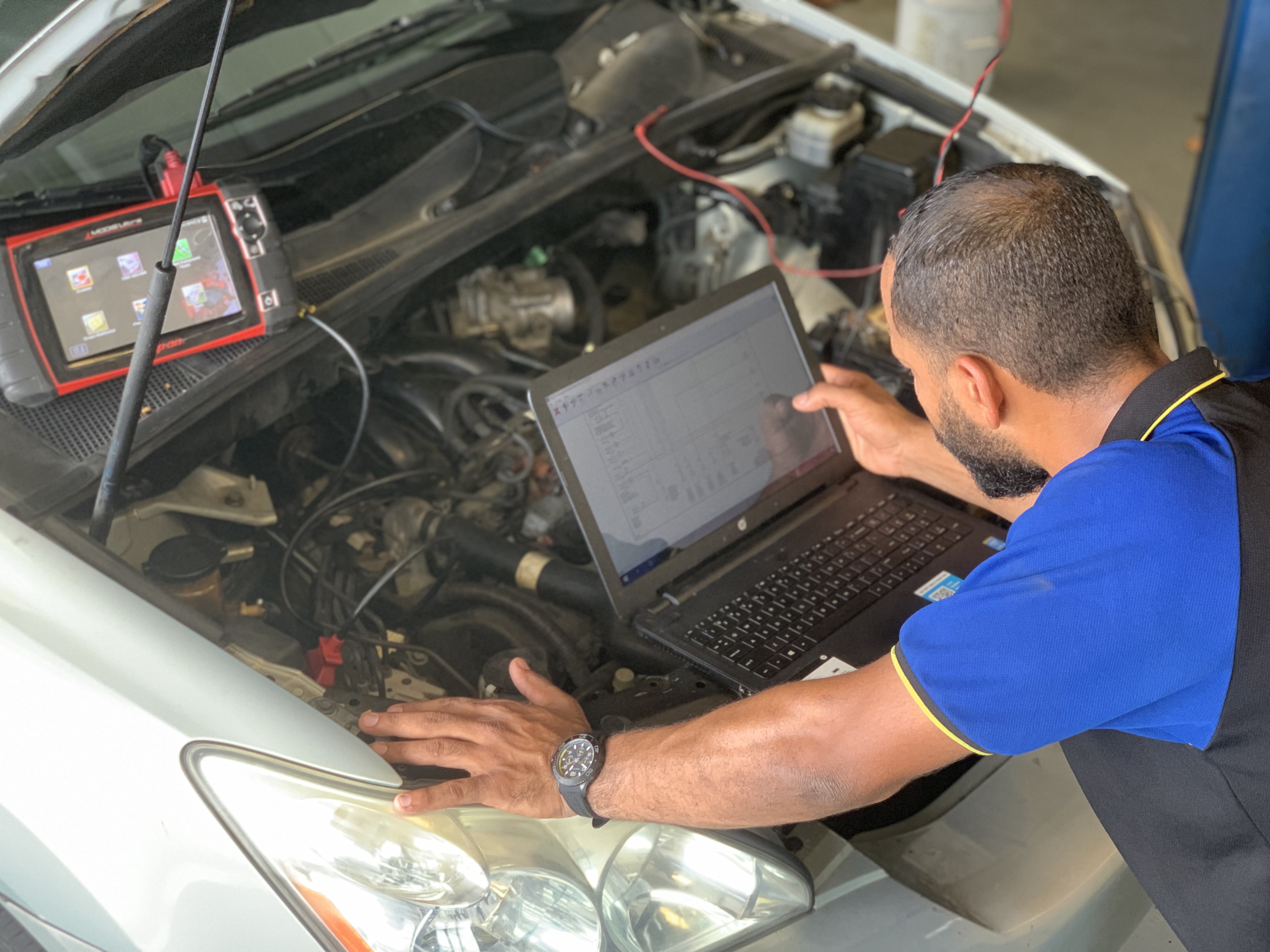 Technician diagnosing an engine